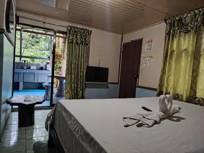 a bedroom with a bed with a towel on it at Vértice Blue Mountain Lodge in San Lorenzo