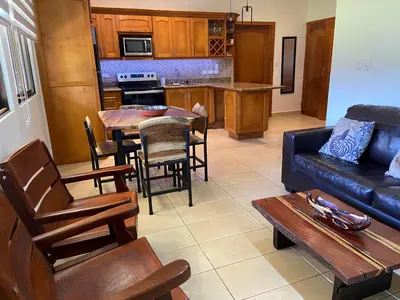 a living room with a couch and a table at Fun in the sun, ground floor, 2 Bedroom, with pool, close to ocean in Coco