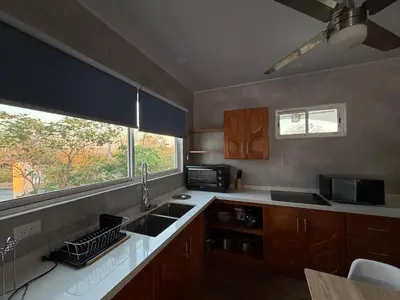 a kitchen with a sink and a window at Villa Sol Kite House in La Cruz