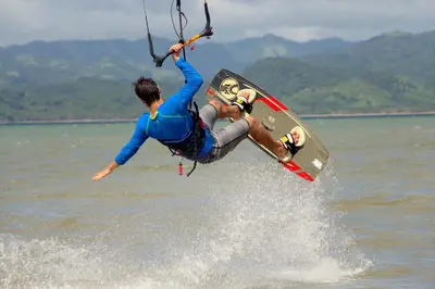 a man is doing a trick on a board in the water at Villa Sol Kite House in La Cruz