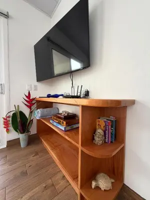 a shelf with a television on a wall at Villa Sol Kite House in La Cruz