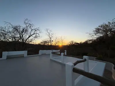 a view of the sunset from the roof of a building at Villa Sol Kite House in La Cruz