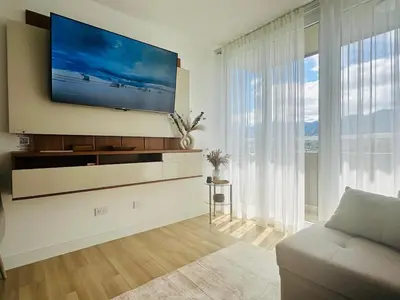 a living room with a flat screen tv on a wall at Secure & Confortable Apartment with green spaces in San Rafael
