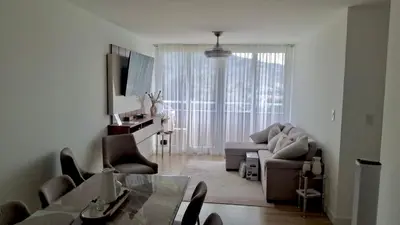 a living room with a couch and a table at Secure & Confortable Apartment with green spaces in San Rafael