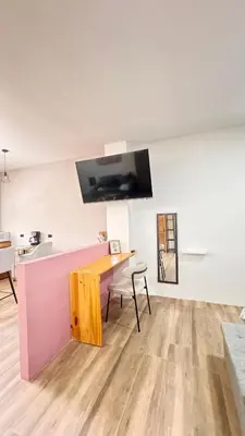 a living room with a wooden table and a desk at GZ Suites in Coco