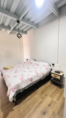 a bedroom with a bed and a wooden floor at GZ Suites in Coco