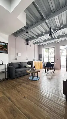 a living room with a couch and a table at GZ Suites in Coco
