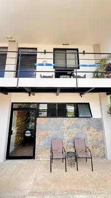 two chairs and a table in front of a building at GZ Suites in Coco