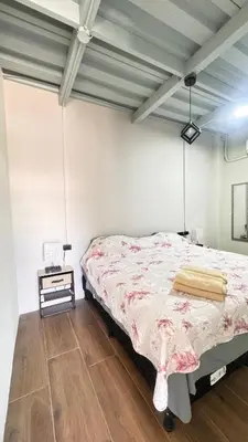 a bedroom with a bed and a wooden floor at GZ Suites in Coco
