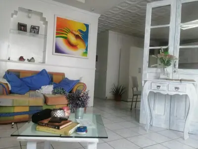 a living room with a couch and a table at Casagerardine in Alajuela City