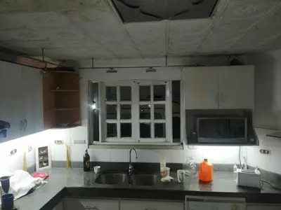 a kitchen with a sink and a microwave at Casagerardine in Alajuela City