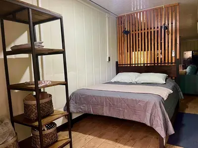 a bedroom with a bed and a book shelf at Casa el Manú Finca Agroecologíca in Marsella