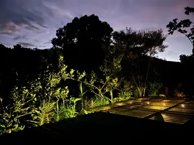 a garden with flowers and a pathway at night at Casa el Manú Finca Agroecologíca in Marsella