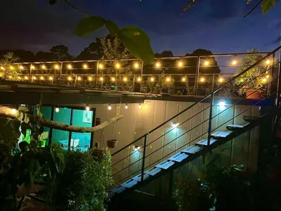 a string of lights on a building at night at Casa el Manú Finca Agroecologíca in Marsella