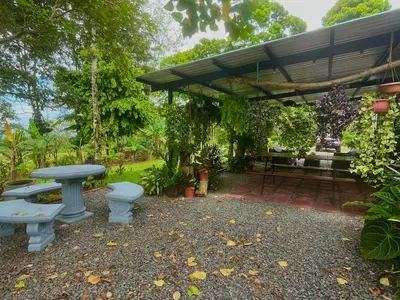 a patio with a table and a picnic table at Casa el Manú Finca Agroecologíca in Marsella