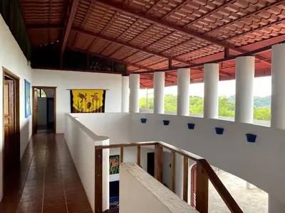 a hallway of a building with a staircase and pillars at Casa Castillo in Quepos