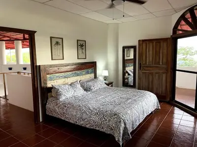 a bedroom with a bed in a room at Casa Castillo in Quepos