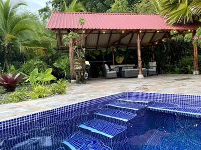 a swimming pool with a gazebo in a yard at Casa Castillo in Quepos