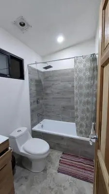 a bathroom with a toilet and a bath tub at Pura Vida Jungle Retreat 1 Bed Up in Montezuma