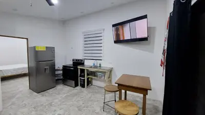 a kitchen with a refrigerator and a table and a counter at Pura Vida Jungle Retreat 1 Bed Up in Montezuma
