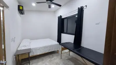 a small room with a bed and a shelf at Pura Vida Jungle Retreat 1 Bed Up in Montezuma