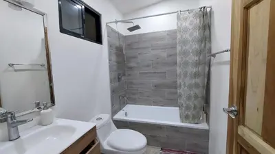 a bathroom with a toilet and a tub and a sink at Pura Vida Jungle Retreat 1 Bed Up in Montezuma