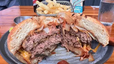 a sandwich cut in half on a plate with fries at Casa Paraíso Boho Uvita Your Piece of Paradise in Uvita