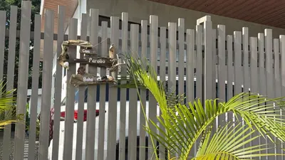 a white picket fence with a sign on it at Casa Paraíso Boho Uvita Your Piece of Paradise in Uvita