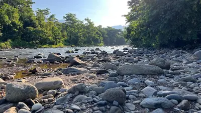a river filled with lots of rocks and trees at Casa Paraíso Boho Uvita Your Piece of Paradise in Uvita