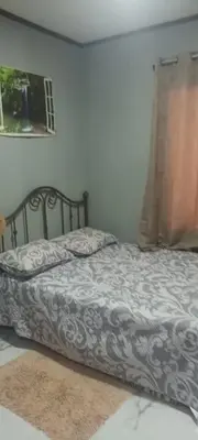 a bed in a bedroom with a bedspread on it at Casa Pura vida in Ojochal