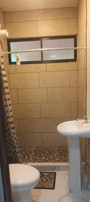 a bathroom with a toilet and a sink at Casa Pura vida in Ojochal