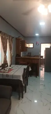 a dining room with a table and a piano at Casa Pura vida in Ojochal