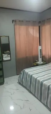 a bedroom with a bed with a striped blanket and a window at Casa Pura vida in Ojochal