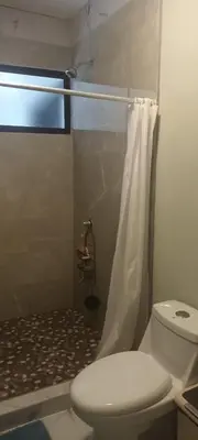 a bathroom with a white toilet and a shower at Casa Pura vida in Ojochal