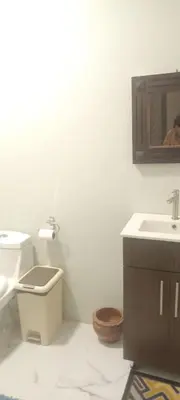 a white bathroom with a toilet and a sink at Casa Pura vida in Ojochal