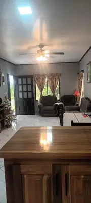 a living room with couches and a ceiling fan at Casa Pura vida in Ojochal