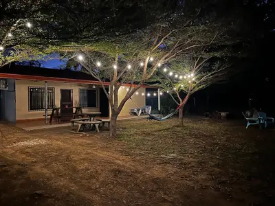 a group of lights on trees in a yard at night at 3-bedroom accommodation in Tamarindo in Garita