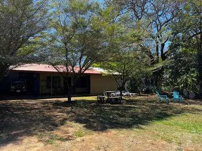 a house with a picnic table and chairs in a yard at 3-bedroom accommodation in Tamarindo in Garita