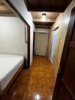 a small room with a bed and a tiled floor at 3-bedroom accommodation in Tamarindo in Garita