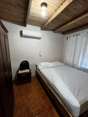 a small bedroom with a bed and a window at 3-bedroom accommodation in Tamarindo in Garita