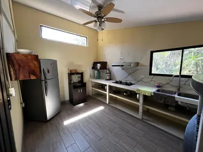 a kitchen with a stainless steel refrigerator and a window at 3-bedroom accommodation in Tamarindo in Garita