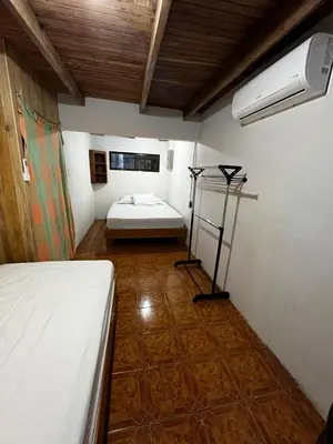 a small room with a bed and a fan at 3-bedroom accommodation in Tamarindo in Garita