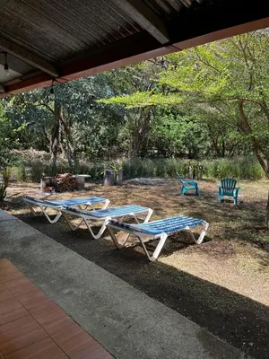 a group of lounge chairs sitting in a yard at 3-bedroom accommodation in Tamarindo in Garita