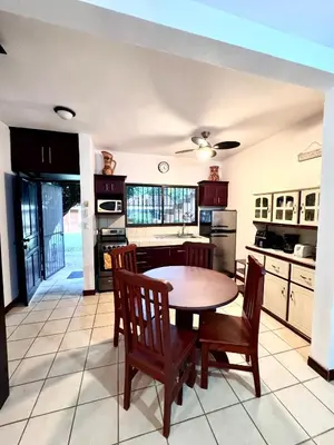 a kitchen with a table and chairs in a room at Sea Heaven Ground Floor Studio in Coco
