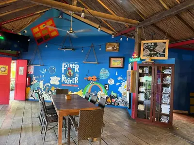 a dining room with a table and a blue wall at Calm & Palms Second Floor Studio in Coco