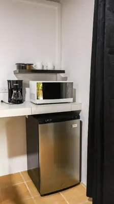 a microwave sitting on top of a counter at Palma Roots in Jacó