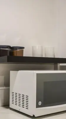 a microwave with two bowls on top of it at Palma Roots in Jacó