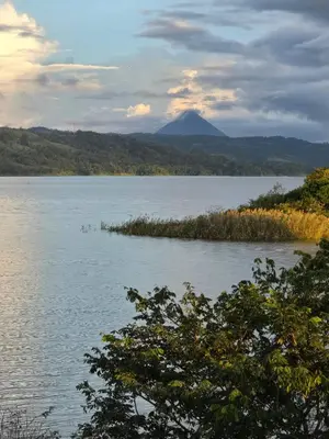 a view of a lake with a mountain in the background at SeStudio Lodge in Nuevo Arenal with Jungle Views in Nuevo Arenal
