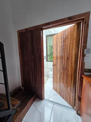 an open wooden door in a room with a window at SeStudio Lodge in Nuevo Arenal with Jungle Views in Nuevo Arenal