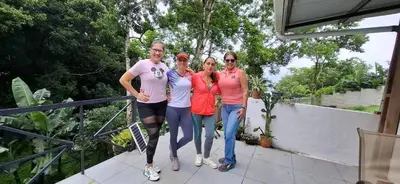 a group of people standing on a balcony at Stay at Alexas Nature House in Nuevo Arenal